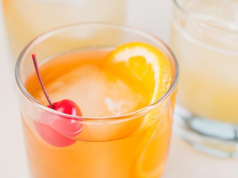 Colorful bright cocktail decorated with ice, sugar and fruit. Cooling drink. Fresh beverage