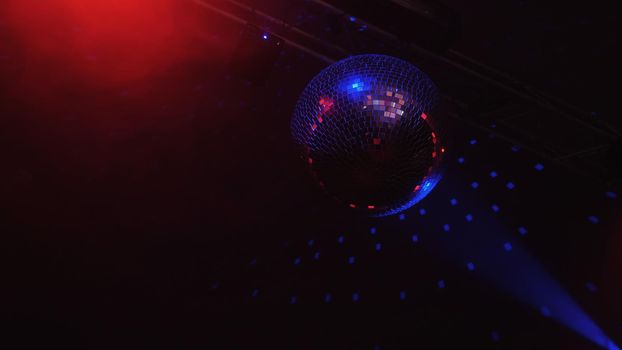 Beautiful Disco Ball Spinning seamless with flares. Mirror ball with bright rays, night party background footage.