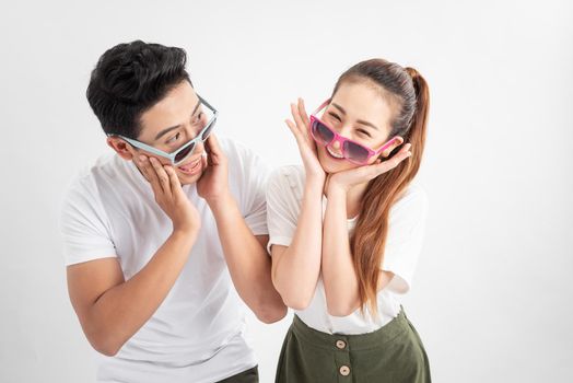 Close-up portrait of two nice attractive adorable cheerful people husband wife in eyeglasses eyewear touches cheeks with both hands over white background