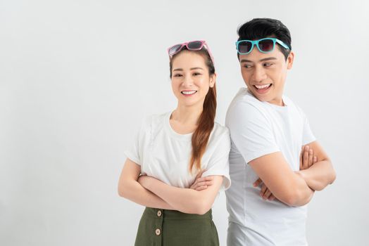 young couple smiling at the light on a light background