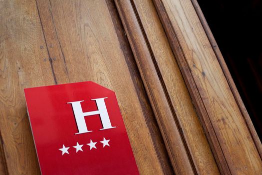 Hotel sign on a wooden door in Le Marais Paris