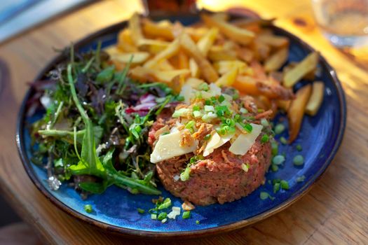 Appetizing rax meat dish in a blue plate