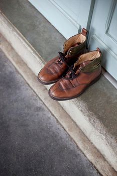 Pair of shoes on a doorstep Place des Vosges in Paris