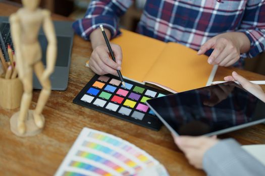 A group of professional web developer and graphic designer working together in the office.