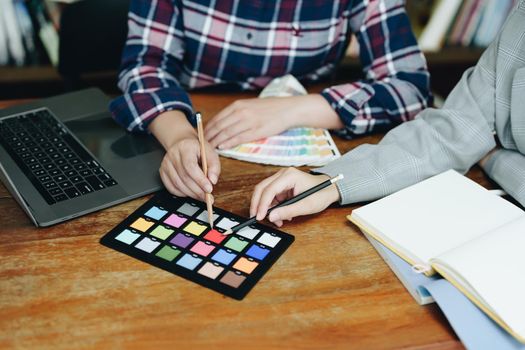 A group of professional web developer and graphic designer working together in the office.