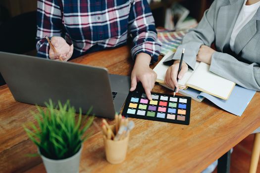 A group of professional web developer and graphic designer working together in the office.