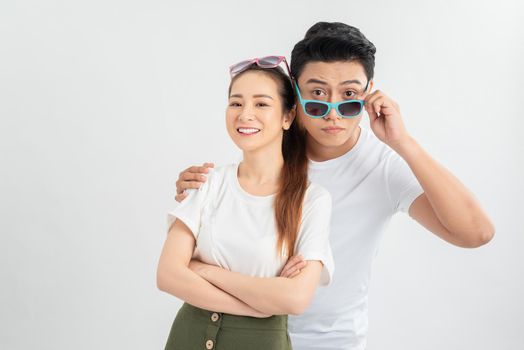 Shocked young friends or family couple dropping eyeglasses, feeling amazed head shot portrait