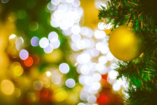 Christmas ball decoration on yellow background. Colorful blur bokeh background. christmas background