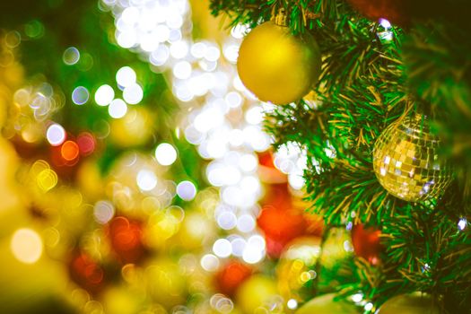 Christmas ball decoration on yellow background. Colorful blur bokeh background. christmas background