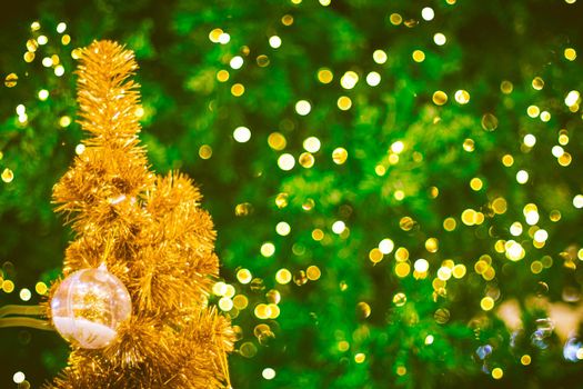 Christmas ball decoration on yellow background. Colorful blur bokeh background. christmas background