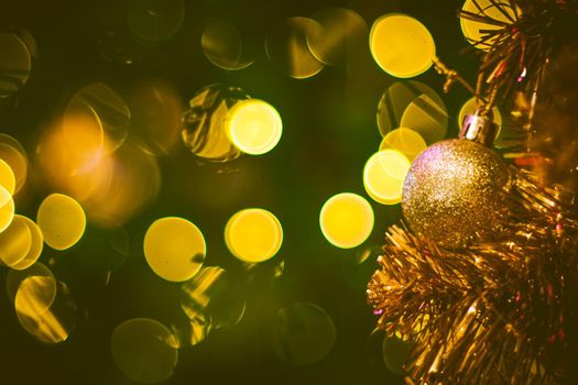 Christmas ball decoration on yellow background. Colorful blur bokeh background. christmas background