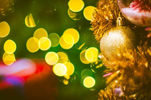 Christmas ball decoration on yellow background. Colorful blur bokeh background. christmas background