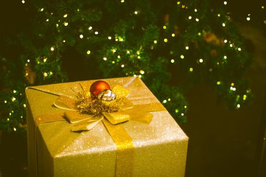Closeup photo of gold christmas gift box with golden ribbon