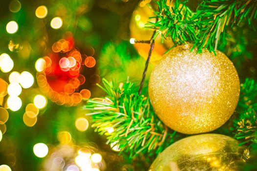 Christmas ball decoration on yellow background. Colorful blur bokeh background. christmas background