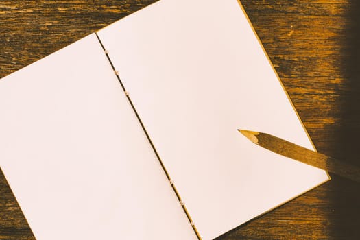 a nature wood pencil on a clean piece of white paper book.