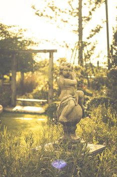 Vintage  image of countryside garden with water well in rustic village