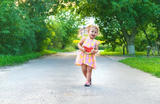 Child girl eats watermelon in summer. Selective focus. food.