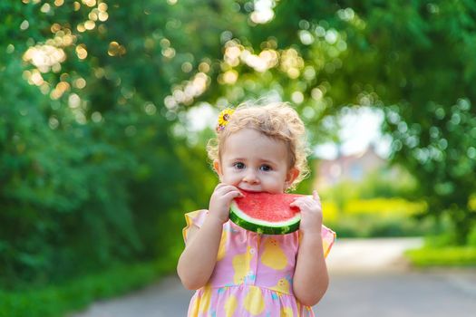 Child girl eats watermelon in summer. Selective focus. food.