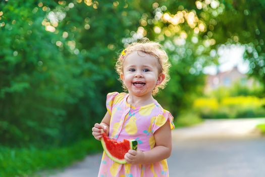 Child girl eats watermelon in summer. Selective focus. food.