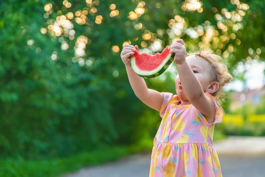 Child girl eats watermelon in summer. Selective focus. food.