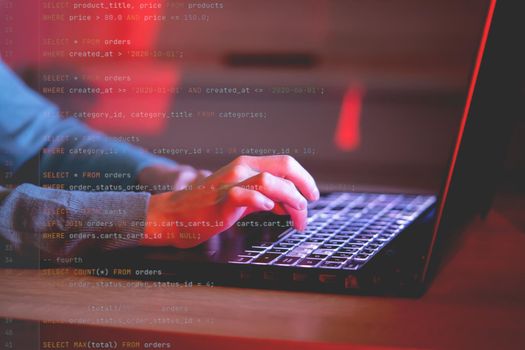 A young girl works on a laptop late at night online, a woman is coding, writing a program, using her device to create a new project and e-learning, getting an IT education for future development.