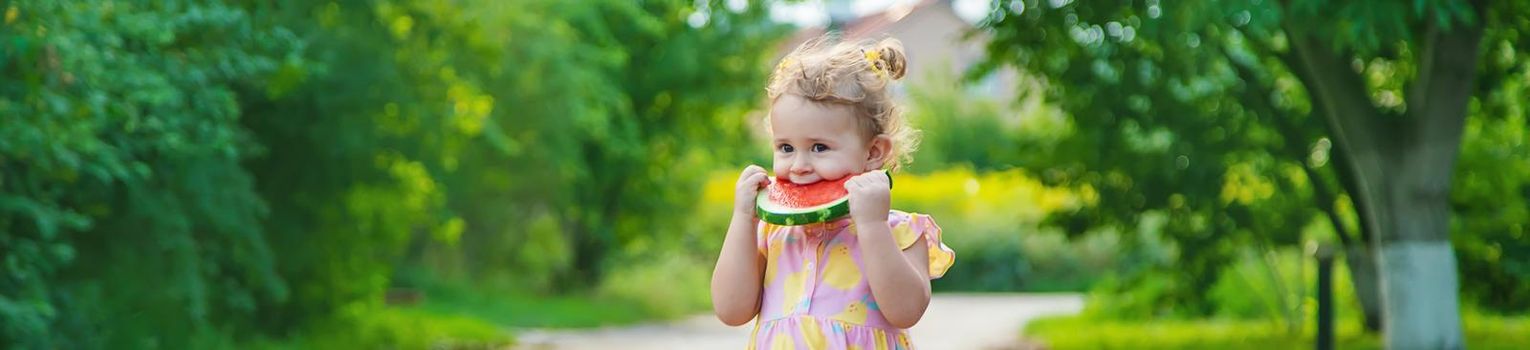 Child girl eats watermelon in summer. Selective focus. food.