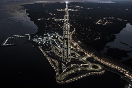 Russia, St. Petersburg, 16 August 2022: Aerial view of futuristic landscape of the highest skyscraper in Europe Lakhta Center for the gas and oil company Gazprom at sunset, magic night illumination. High quality photo
