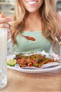 girl eating delicious typical mexican food, tacos, sopes, pastor, etc. variety of delicious typical mexican food