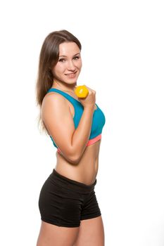Young sporty girl does exercise standing dumbbells in yellow color on a white background.