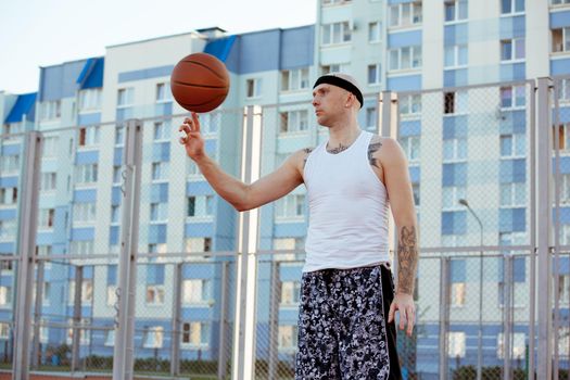 Young man standing on a basketball court.