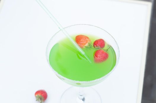 Colorful bright green cocktail cactus with strawberries, delicious refreshing summer drink, tonic drinks. High quality photo