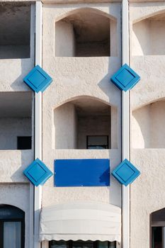 Typical white house facade part in italian city near the sea. Mediterranean village style architecture.