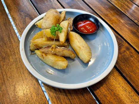Baked potato wedges with shredded onion and herbs and tomato sauce platted homemade organic vegetable vegan vegetarian potato wedges snack food meal