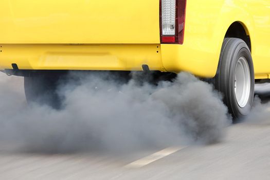 Air pollution from vehicle exhaust pipe on road