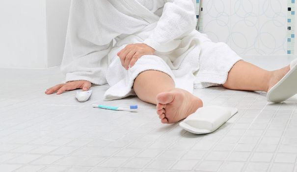 Woman falling in bathroom because slippery surfaces