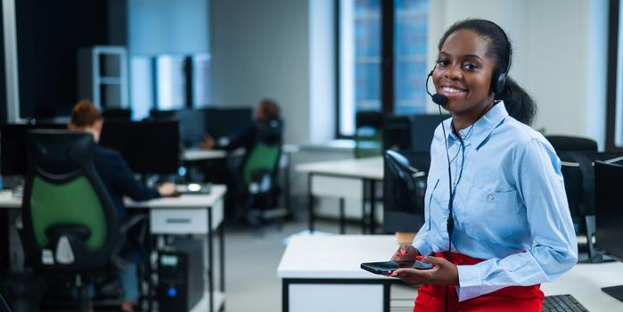 African female call center employee using smartphone