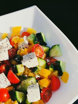 Fresh vegetable greek salad with cherry tomatoes, bell pepper, cucumber, feta cheese, olive oil and seasonal spices, healthy food diet and delicious meal recipe concept