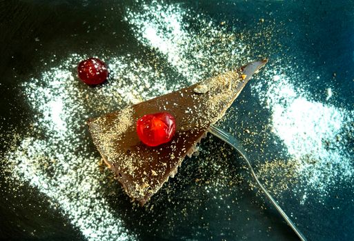 a gourmet piece of chocolate cake, torte on a decorated plate. Top view