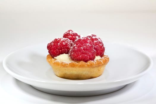 Raspberry cake on a plate in a tea room