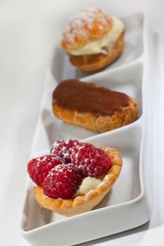 Various French pastries on a white porcelain dish