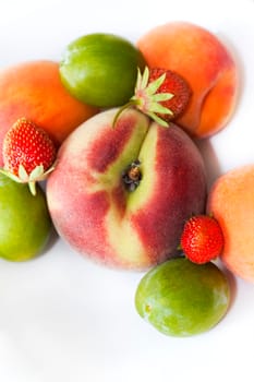 Close up of summer fruits on a white table