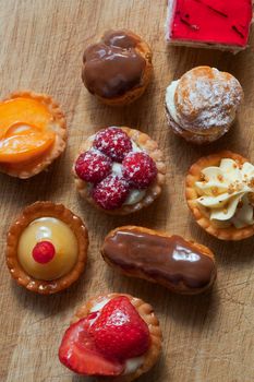 Various cakes on a wooden board in a bakery