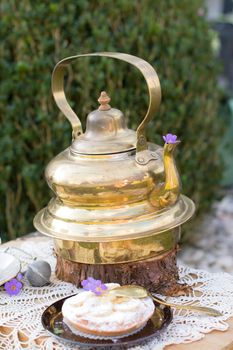 copper vintage teapot and banana cream cake at picnic outdoor,vintage background,High quality photo