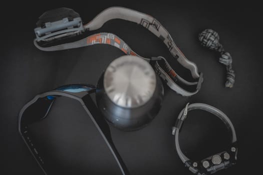 Flatlay from a bunch of Outdoor equipment,  on a dark background.