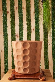 earthenware pot for plants on a wooden table with green plant background. catalog of plant pots. clay pot for plants.