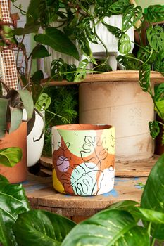 earthenware pot for plants on a wooden table with green plant background. catalog of plant pots. clay pot for plants.