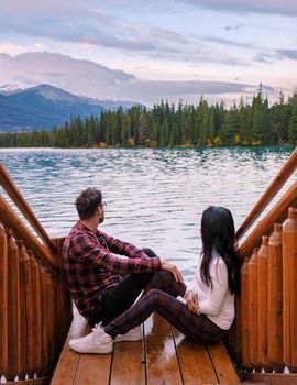 couple at Beauvert lake, sunrise by the lake at Jasper, Lac Beauvert Alberta Canadian Rockies Canada. men and women watching the sunrise by the lake in Jasper Canada