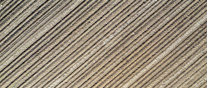 Banner of a clear plowed field with traces. View from the top.