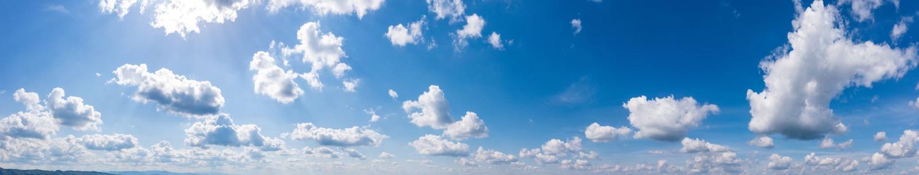 Panoramic view of blue sky with fluffy clouds