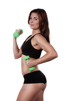 Fitness smiling girl with dumbbells on a white background in black clothes